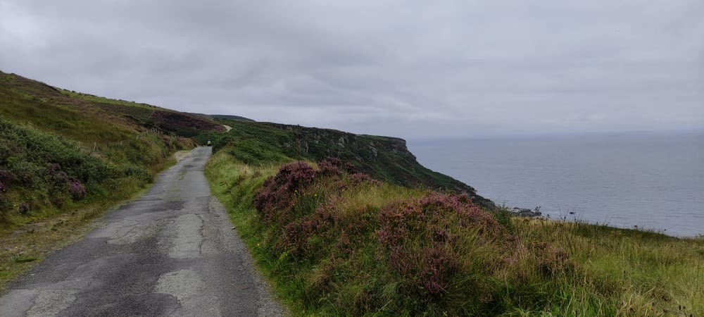 a road on a hill by the water