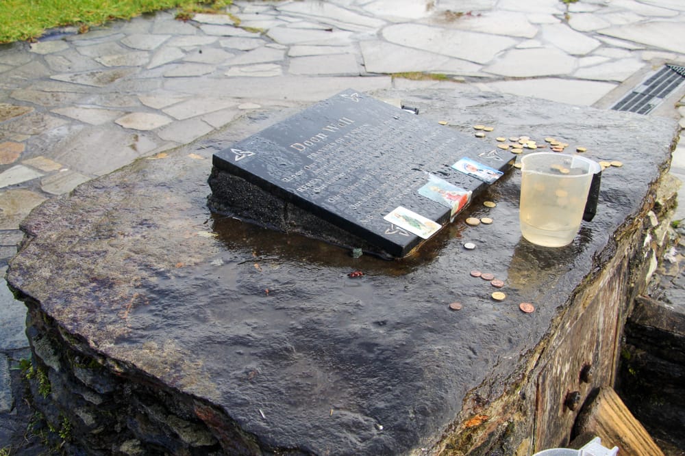 a bucket of water on a stone surface