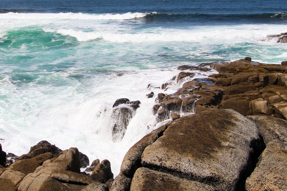 a rocky beach with waves crashing