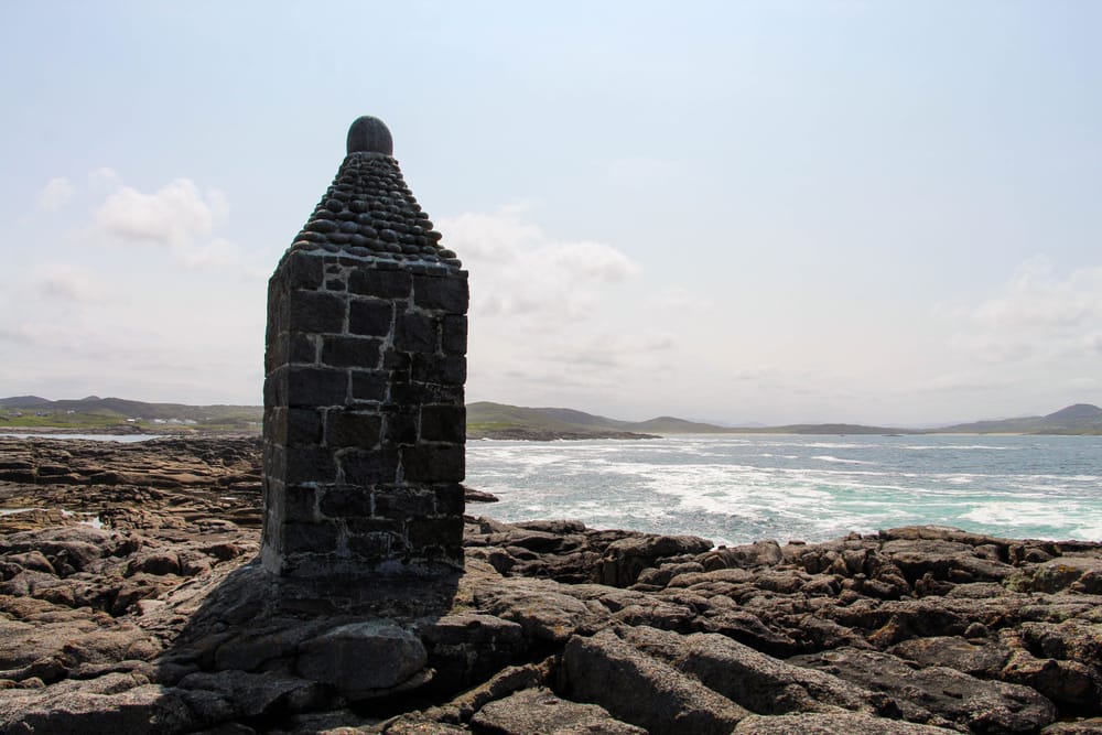 a stone tower on a rocky beach