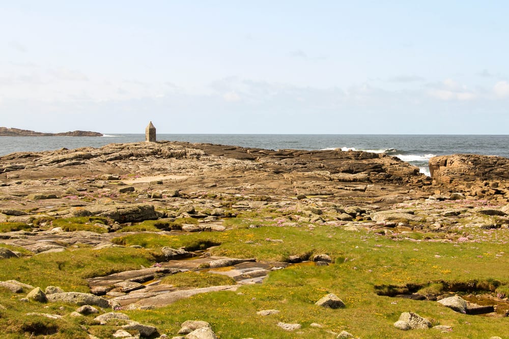a rocky beach with a lighthouse